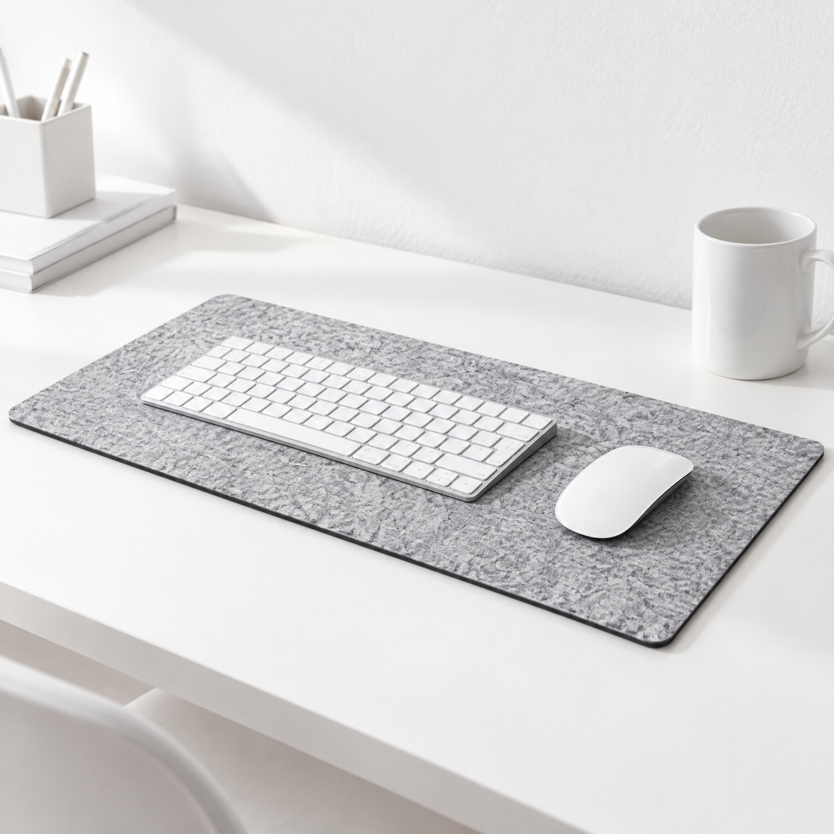 Felt desk mat in light grey on a white desk
