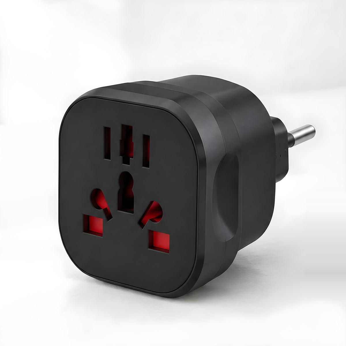 Layover universal travel adapter with EU plug, matt black, universal socket on the front, on a white desk