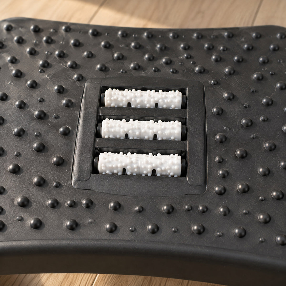 Close-up of the three massage rollers and raised bumps on the Ease footrest