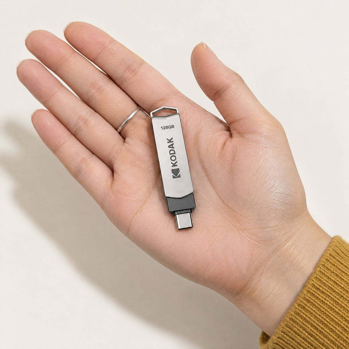 Ferry flash drive resting on an open palm, shown at its real size