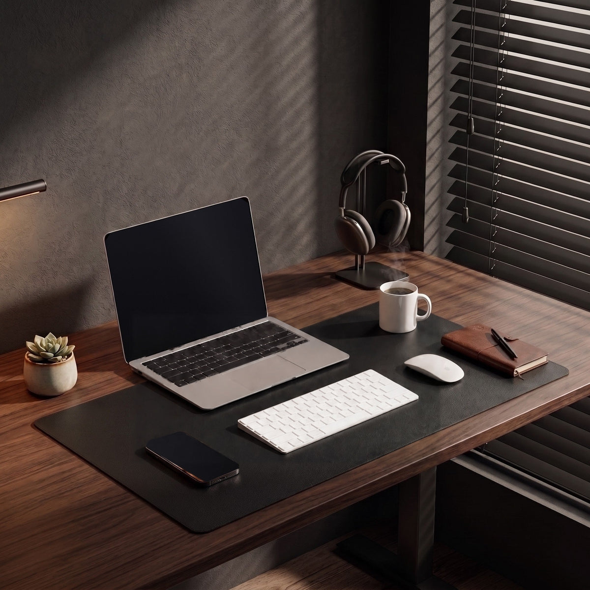 Flow desk mat in black under a laptop and keyboard