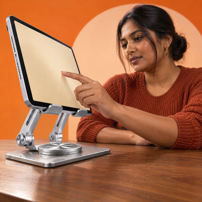 Woman tapping a tablet held in landscape on the Pivot rotating aluminium stand