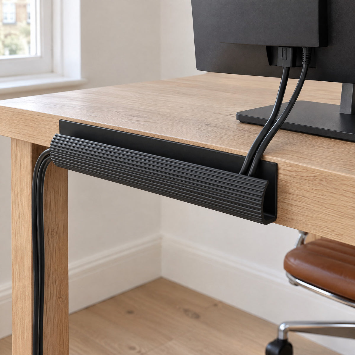 Rail cable channel on the back of a desk gathering the monitor cables