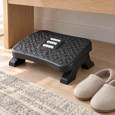 Ease footrest under an oak desk beside a pair of slippers