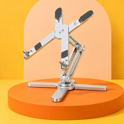 Silver AeroSpin 360 laptop stand on an orange podium against a yellow and peach backdrop