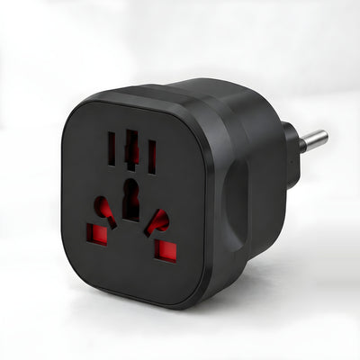 Layover universal travel adapter with EU plug, matt black, universal socket on the front, on a white desk