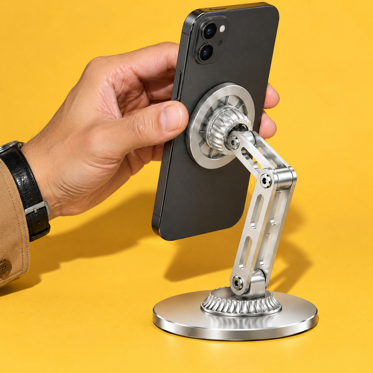 Hand placing a phone on the magnetic head of the silver Crane stand