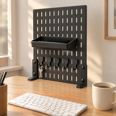 Black Trellis pegboard clamped to the back edge of an oak desk, a phone resting in its tray