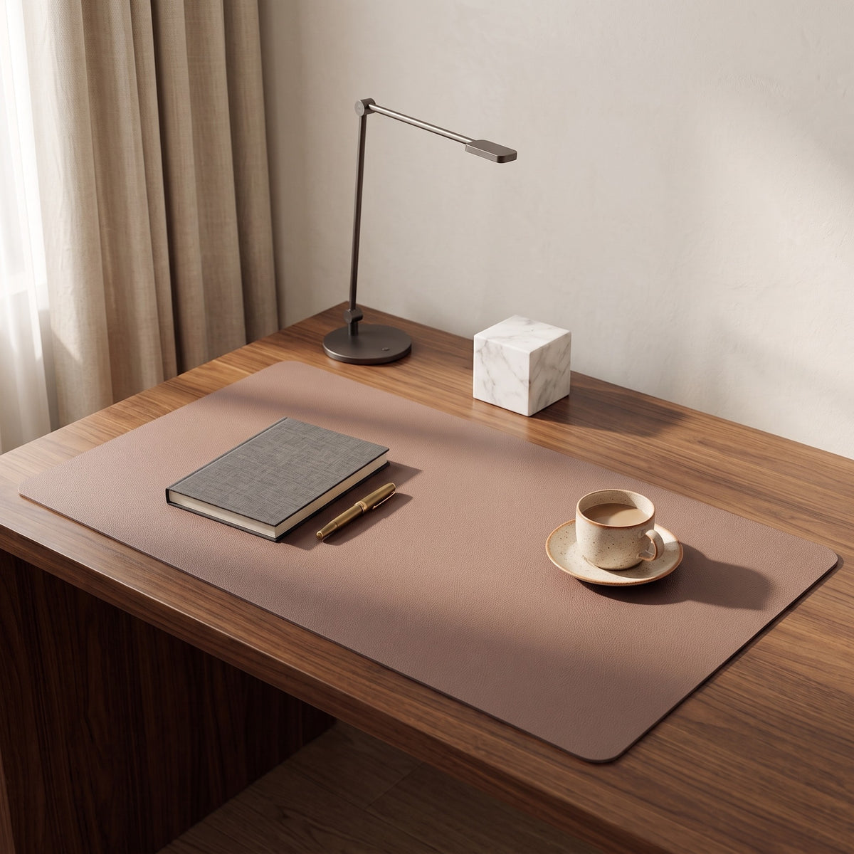 Faux leather desk mat on a wooden desk with a notebook and a cup of coffee