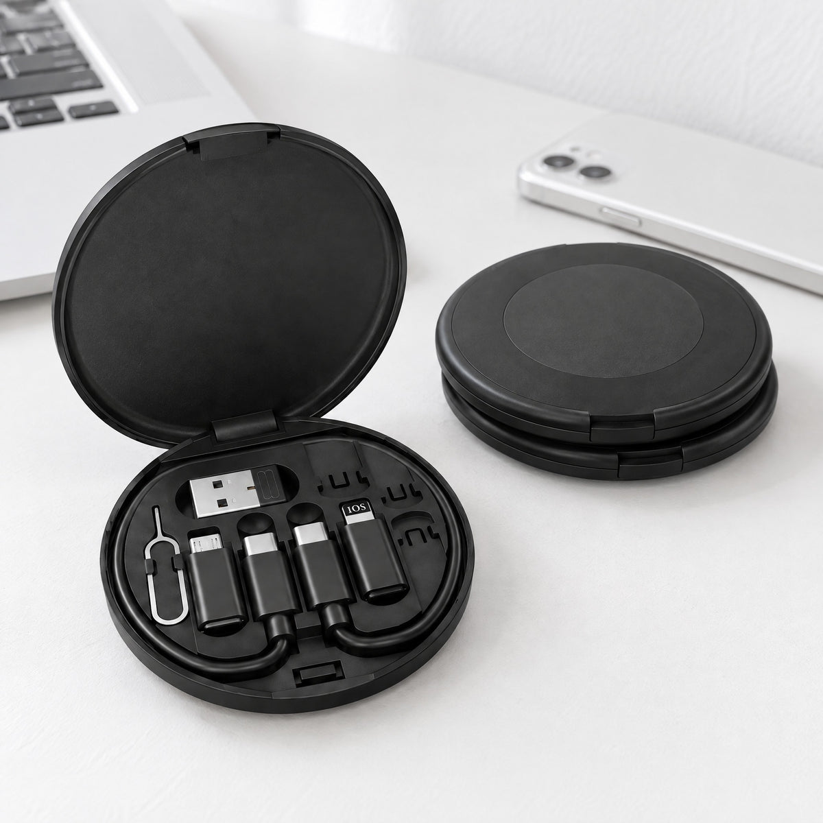 Three Locket cable and adapter kits on a white desk, one case open to show the USB-C cable, three adapters and SIM pin in their slots