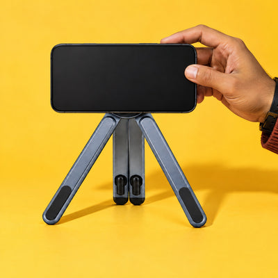 Hand placing a phone on the magnetic disc of the Span stand set up as a tripod